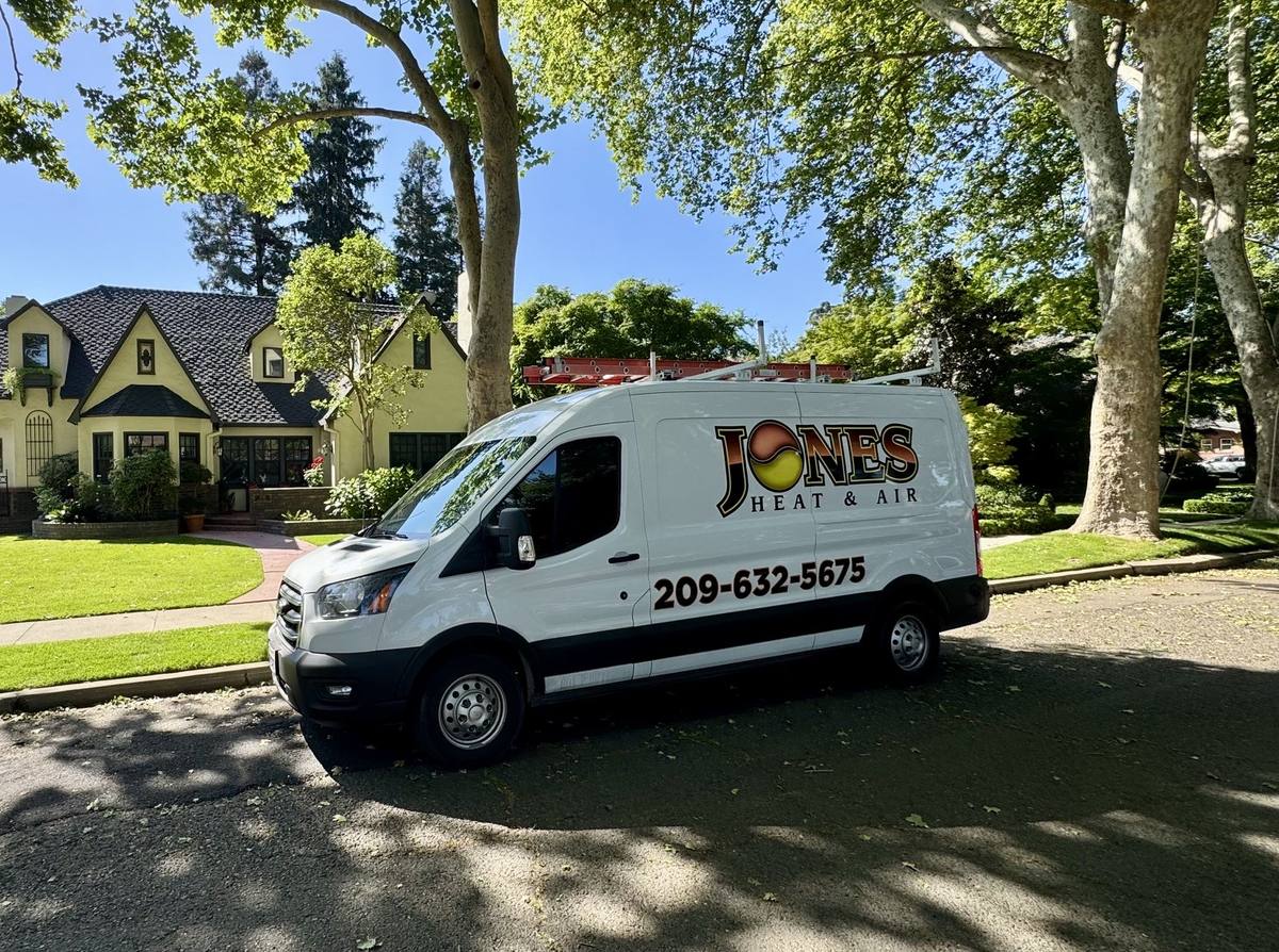 Jones Heat & Air technician van parked at a residential service call